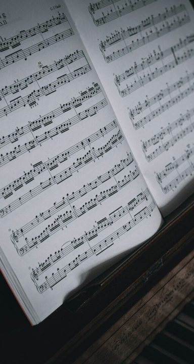 sheet music sitting on top of a piano